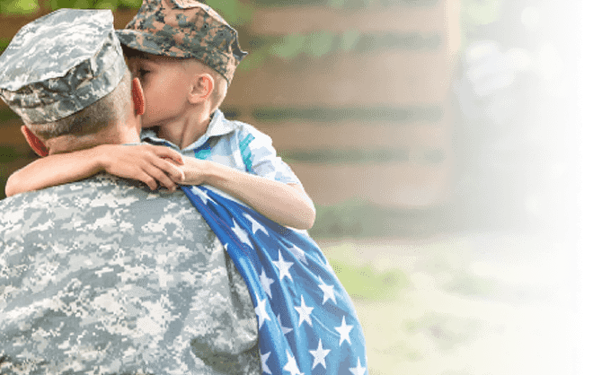 Solider hugging his child